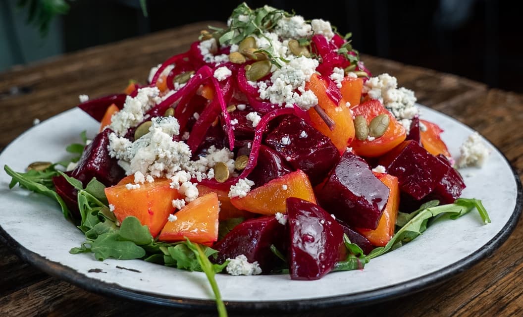 Beet salad with arugula, goat cheese, and pumpkin seeds